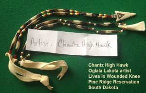 At the end of one is a buffalo tooth; at the end of the other is buffalo bone.